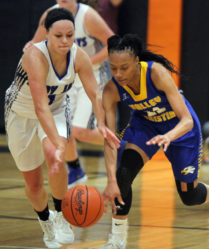 William D. Lewis The Vindicator   Valley Christian Imane Snyder(11) and Jackson's Emily Williams(3) during 2-28-18 action at Ridge.