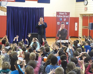 Neighbors | Zack Shively.The students had an active role in Brian Richards performance. He asked often asked them to participate in what he did. Pictured, Richards went over the five food groups with the children.