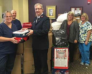 Neighbors | Submitted. Major Paul Moore of the Salvation Army was greeted by hundreds of shoes and socks recently collected by Ankle & Foot Care Centers. Pictured with Major Moore are staff members Stacy Doyle, Kevin Smotrilla, Kelly Anders and Debbie Minetti.