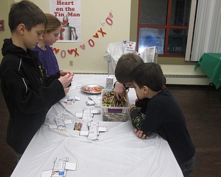 Neighbors | Zack Shively.The Wizard of Oz's Valentine Celebration at the Boardman library had a number of crafts and games for the children. One of the crafts, pictured, had the families color and fold cubes that showed characters from "The Wizard of Oz" once they finished.