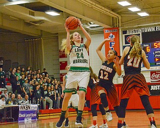 Scott Williams - The Vindicator - West Branch's Sarrah Tennefoss (#24) goes up for a shot while Howland's Jenna DeSalvo (#12) and Alex Ochman (#20) try to block at their playoff game at Austintown Fitch on Thursday March 1, 2018.