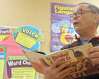 David Leo, the father of slain Girard Police officer Justin Leo and retired principal of Girard Intermediate School, reads a book to sixth-graders during Right to Read activities at the school. This book, “Baseball Saved Us,” is a book Justin enjoyed reading to classes when he volunteered for Read Across America Day.