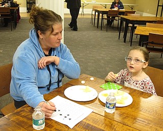 Neighbors | Zack Shively.Those who attended the "Bet You Can't Eat Just One!" event at the Poland library stayed and talked after the presentation to discuss the results of the blind taste test and what they liked in potato chips. Pictured, Bernadette Stafford asked her daughter Rylynn about the chips in the taste test.