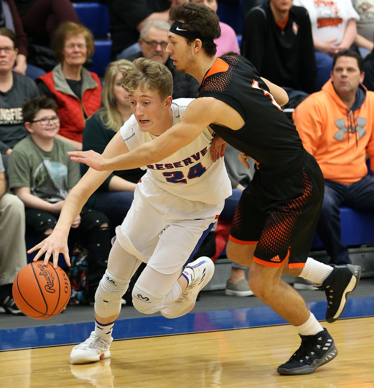 BERLIN CENTER, OHIO - MARCH 2, 2018:  Western Reserve's Kade Hilles (24) drives to the hoop against  Springfield's Brandon Walters (3) during the 1st qtr at Western Reserve High School.  MICHAEL G. TAYLOR | THE VINDICATOR