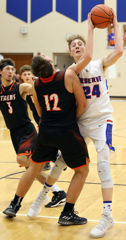 BERLIN CENTER, OHIO - MARCH 2, 2018:  Western Reserve's Kade Hilles (24) drives to the hoop against  Springfield's Shane Eynon (12) the 2nd qtr at Western Reserve High School.  MICHAEL G. TAYLOR | THE VINDICATOR