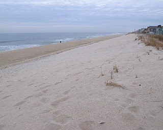 This March 1, 2018 photo shows the newly widened beach in Mantoloking, N.J. hours before a powerful coastal storm was due to hit the area. Federal officials say there's no guarantee that sand washed away from the as-yet unfinished project over the next two days will be replaced. (AP Photo/Wayne Parry)