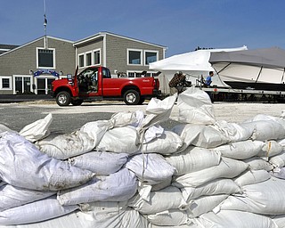 Sandbags fill  the boat ramp at Outermost Harbor Marine as crews move the last of several boats to a safer spot as preparations are underway for the approaching storm, Thursday, March 1, 2018 in Chatham, Mass. (Steve Heaslip/The Cape Cod Times via AP)