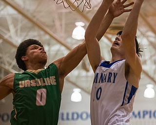 Poland's Dan Kramer goes for a layup against the defense of Ursuline's Devan Keevey during Poland's 68-47 sectional tournament win in Poland on Friday night...Photo by Dianna Oatridge