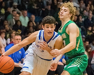 Poland's Braeden O'Shaughnessy drives past Ursuline's Vince Armeni during Poland's 68-47 sectional tournament win at Poland on Friday night...Photo by Dianna Oatridge.