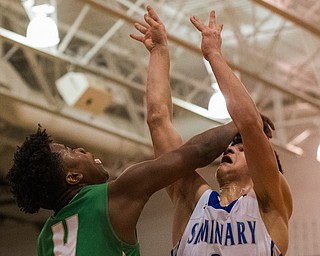 Ursuline's Travis Easterly and Poland's Braeden O'Shaughnessy battle for a rebound during the third quarter of sectional tournament action in Poland on Friday night. Poland won 68-47...Photo by Dianna Oatridge