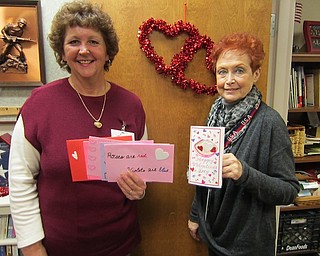 Karen Shesko, above left, a member of American Legion Auxiliary 737 of Lake Milton, and Lori Stone (USAF, retired), volunteer coordinator at the Youngstown Veteran’s Affairs Clinic, prepare to distribute valentines created by local students for veterans visiting the clinic. The auxiliary has participated in the program for many years.