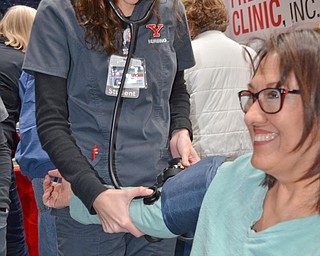 Michelle Jamieson has her blood pressure taken by YSU Nursing student Ariana A. Pasqual. Pasqual was volunteering at the Bitonte College of Health and Human Services table at the Valley Health and Wellness Expo, held at Covelli Center on Saturday, March 3, 2018...Photo by Scott Williams, The Vindicator...