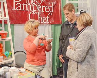 Chrisi Ricker from The Pampered Chef explains her product to Susie Pavelko and Dean Fuller at the HBA Home and Garden Show held at Mr. Anthony's in Boardman on Saturday March 3, 2018...Photo by Scott Williams, The Vindicator.