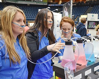 Three Mercy College of Ohio students, from left to right, Autumn Miller, Lauren McIntosh, and Maria Patsko try out an Euphorium Oxygen Bar at the Boardman Medical Supply booth at the Valley Health and Wellness Expo at the Covelli Centre on Saturday March 3, 2018. An Euphorium Oxygen Bar is recreational oxygen and can be rented for private events and parties. ..Photo by Scott Williams, The Vindicator..