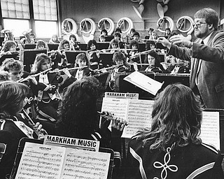 Twenty-three area concert and symphonic bands were in the spotlight Friday evening and Saturday as the Ohio Music Education Association held its 1987 District Band and Chorus Contest at Niles McKinley High School. The bands competed in four classes, from A to D, depending on size. Each played three pieces and was judged by a panel of four...With the early morning sun shine into the rehearsal room, the conductor of Pymatuning Valley High School Band, Paul A. McCarty, set the music in motion...Photo by Robert K. Yosay, The Vindicator..