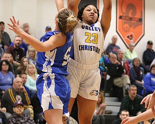 Valley ChristiansNe'Syiah Taylor (23) goes up for a shot while being defended by Lisbon's Chloe Smith (5) during the first half of Saturday afternoons championship matchup at Mineral Ridge. Dustin Livesay | The Vindicator 3/3/18 Mineral Ridge.