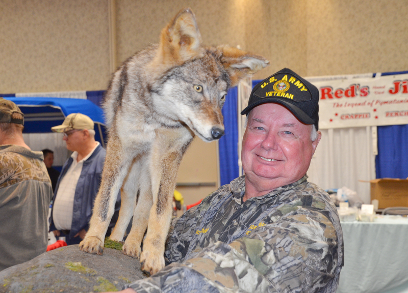 Tom Bechdel, from Meadville, PA, carries his stuffed and mounted coyote back to the car as The Sportsman's Hunting and Fishing Supershow and Sale draws to a close at the Metroplex Expo Center in Girard, Ohio on Sunday March 4, 2018.  Bechdel had a booth set up and was selling a coyote hunting DVD that he made...Photo by Scott Williams - The Vindicator.