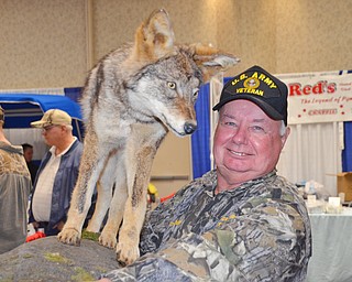 Tom Bechdel, from Meadville, PA, carries his stuffed and mounted coyote back to the car as The Sportsman's Hunting and Fishing Supershow and Sale draws to a close at the Metroplex Expo Center in Girard, Ohio on Sunday March 4, 2018.  Bechdel had a booth set up and was selling a coyote hunting DVD that he made...Photo by Scott Williams - The Vindicator.