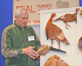 Jim Pasquale, from Howland, Ohio, demonstrates one of his hand made turkey calls at The Sportsman's Hunting and Fishing Supershow and Sale at the Metroplex Expo Center in Girard, Ohio on Sunday March 4, 2018.  Pasquale has hand carved turkey calls and wall decorations for nearly twenty-five years since his retirement. ..Photo by Scott Williams - The Vindicator.