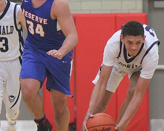 William D. Lewis The Vindicator McDonald's Braedon Poole(30) scoops up a loose bll past Western Reserve's Jck Cappabianca(34) during3-5-18 action at Struthers.