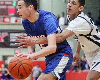 William D. Lewis The Vindicator Western Reserve's Dom Velasquez(2) drives past McDonald's Braedon Poole.