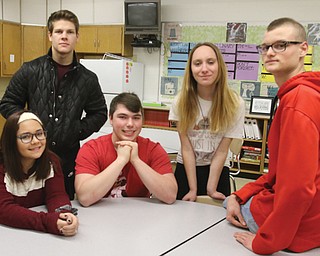 Canfield High School seniors spent some time interning at local companies this semester. Sitting, from left, are Sydney Fabry and Jared Cross, and on the table is Cullen Brady. Standing from left are Connor Dye and Nichole Breuer.