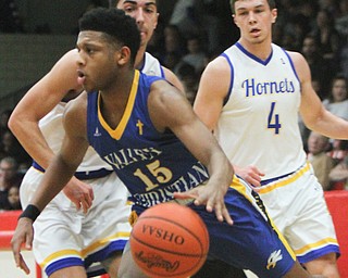 William D. Lewis The Vindicator  Valley'sJordan Trowers(15) drives around East Canton's Dallas Moldovan(14) and Anthony Baad(4) during 3-6-18 action in Struthers.