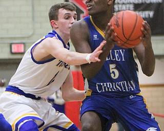 William D. Lewis The Vindicator  Valley'sJMilan Square(5)) drives around  Anthony Baad(4) during 3-6-18 action in Struthers.