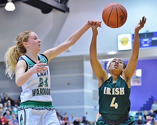 St. Vincent-St. Mary's Faith Williams (right) reaches out for a rebound against West Branch's Sarrah Tennefoss during the second quarter of their Division II regional semifinal game Tuesday at Barberton High School. (Jeff Lange/ABJ/Ohio.com correspondent)