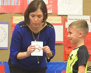 A Poland Union Elementary school teacher works with a first-grader on his math skills at Math Night on Tuesday.