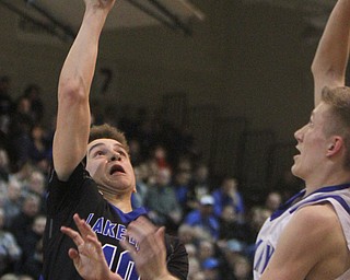 William D. Lewis The Vindicator Lakeview's AJ McClellen(10) shoots past Poland'sJacob Hyrb914) during 3-7-18 action at Boardman.