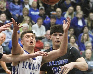 William D. Lewis The Vindicator Poland's Brandon Barringer(13) qnd Lakeview'sDrew Munno(22) during 3-7-18 action at Boardman.