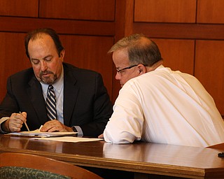 Former Niles Auditor Charles Nader, right,  goes over the plea agreement Nader signed today with Atty. Dan Keating. Nader pleaded guilty in Trumbull County Common Pleas Court to theft in office and two ethics violations in the Ralph Infante public-corruption case. Nader has agreed to testify against Infante in his trial coming up next month.