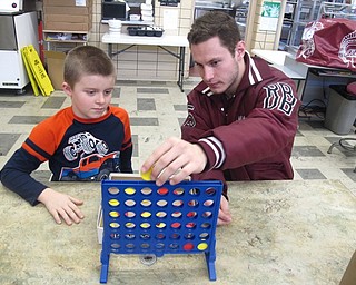 Neighbors | Zack Shively.Michael Melewski, a Big Spartan, said he wants to help his Little Spartan get his mind off class and have fun. Pictured, he and his Little Spartan, Shane Plourde, play Connect Four.