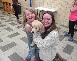 Neighbors | Zack Shively.The Big Spartans entertain the Little Spartans for an hour during school. Pictured is elementary student Alice Whitaker and Madie Murray with her dog Milo that she brought to the school for the program.