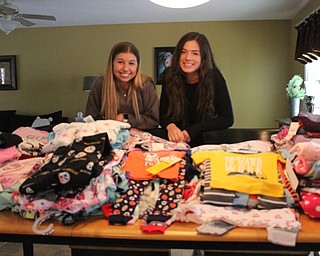 Neighbors | Abby Slanker.Canfield High School seniors Amanda Petro (left) and Amanda Blanco (right) organized a collection of children’s pajamas to be donated to Making Kids Count as their National Honor Society service project during the month of January. Petro and Blanco collected more than 130 pairs of pajamas for infants through 14-year-old children.