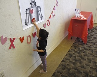 Neighbors | Zack Shively.Jennifer Kuczek and Ashley Young chose to use the movie for their Valentine's event because the Tin Man wanted a heart. Many of the stations they set up during the event centered around the Tin Man, such as the station pictured, "Pin the Heart on the Tin Man," that Mary Jane Katsaras played.