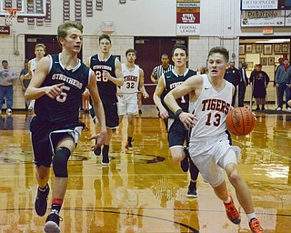 Connor Tamarkin (#13) of Howland moves the ball down court around Carson Ryan (#5) of Struthers during their Thursday, March 8, 2018 game at Boardman High School...Photo by Scott Williams - The Vindicator.