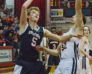 Carson Ryan (#5) of Struthers makes a shot as Nolan Brill (#32) of Howland tries to block during their Thursday, March 8, 2018 game at Boardman High School...Photo by Scott Williams - The Vindicator.