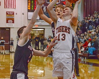 Connor Tamarkin (#13) of Howland tries to make a basket as Isaiah Torreance (#1) and Carson Ryan (#5) of Struthers block during their Thursday, March 8, 2018 game at Boardman High School...Photo by Scott Williams - The Vindicator.