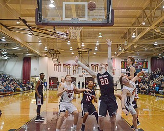 Struthers' Ryan Leonard (#20) and Adrian Brown (#10) try to put points on the board as Howland's Connor Tamarkin (#13) and Nathan Barrett (#40) try to block during their Thursday, March 8, 2018 game at Boardman High School...Photo by Scott Williams - The Vindicator.