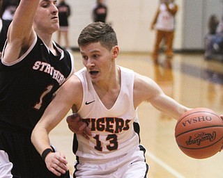 William D. Lewis The Vindicator Howland's Connor Tamarkin(13) drives around struthers Isiah Torrence(1) during 3-8-18 action at Boardman