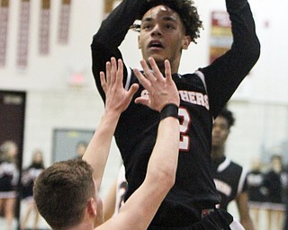 William D. Lewis The Vindicator Struthers Tyrese Hawkins(2) shoots over Howland's Connor Tamarkin(13) during 3-8-18 action at Boardman.