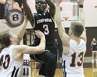 William D. Lewis The Vindicator Struther's Kevin Traylor(3) shoots past Howland's Nathan Barrett(40) and Connor Tamarkin(13) during 3-8-18 action at Boardman.