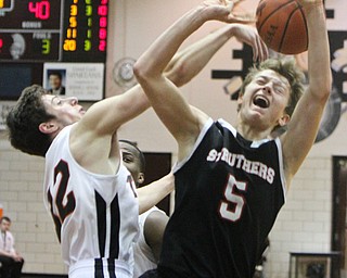 William D. Lewis The Vindicator Struther's Carson ryan(50 has the ball knocked away by)Howland'Nolan Brill(32) during 3-8-18 action at Boardman.