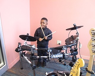 Neighbors | Zack Shively.The Michael Kusalaba library features a MakerSpace for creative patrons of the library. The space combines technology and art. Pictured, Jeremiah Burt played the drums in the sound studio of the MakerSpace.