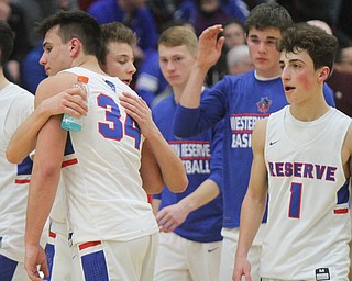 William D. Lewis the Vindicator  WR's Jack Cappabianca(34) is embraced by Riley Miller(13) abfter being defeated by East Canton at Struthers 3-9-18. At right is Ryan Demsky(13),