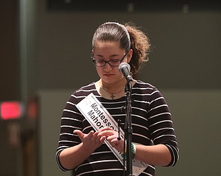             ROBERT  K. YOSAY | THE VINDICATOR..The 85th Spellling Bee at YSU and Kilcawley Center - 44 spellers came  down to  Mackenzie Sambroak 5th grader from Roosevelt Elementary in McDonald...Nina C Dill of Montessori of the Mahoning Valley spells out her word on her hand