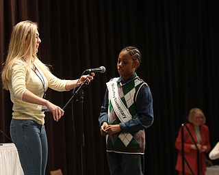             ROBERT  K. YOSAY | THE VINDICATOR..The 85th Spellling Bee at YSU and Kilcawley Center - 44 spellers came  down to  Mackenzie Sambroak 5th grader from Roosevelt Elementary in McDonald...Helping adjust the microphone - is Julia Miglets a past winner as McGuffey Elementary Gabriel Adams 4th grade