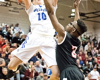 Lakeview's AJ McClellan puts up a shot as Struther's Kevin Traylor defends during the Division II District Title game at Boardman on Saturday. Lakeview won 72-59...Photo by Dianna Oatridge.